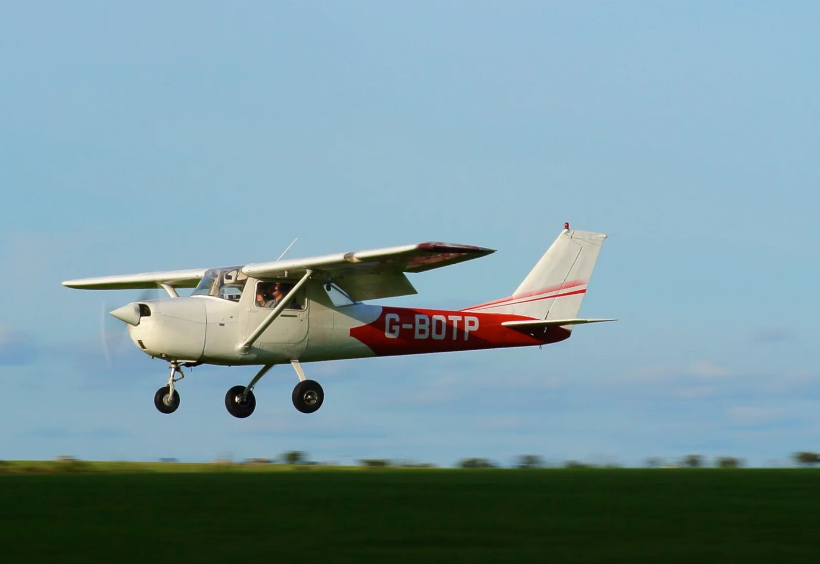 A Cessna 150 taking off — the type the school trains in